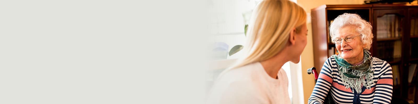 A woman talking with an elderly woman