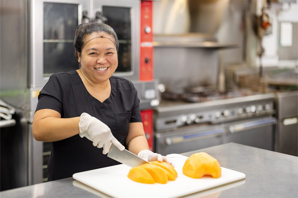 PACS-300x200-food1 Chef cutting fruit at Lewis Park Post Acute